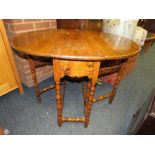 A SMALL ANTIQUE OAK DROPLEAF TABLE WITH BOBBIN TURNED SUPPORTS