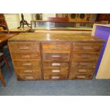A VINTAGE OAK MULTI DRAWER INDUSTRIAL STYLE BANK OF FIFTEEN DRAWERS WITH RE-CLAIMED TOP H-75 W-144