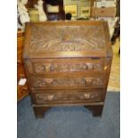 AN ANTIQUE CARVED OAK BUREAU WITH LION MASKS H-102 W-75 CM