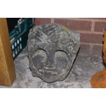 A STONE CARVED FACE