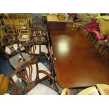 A REPRODUCTION MAHOGANY TWIN PEDESTAL DINING TABLE WITH TWO SPAR LEAVES AND TWELVE CHAIRS