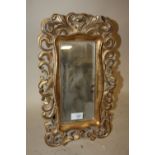 A MODERN EASEL-BACK TABLE TOP MIRROR WITH GILT PIERCED FRAME, OVERALL H. 41 CM, W. 25 CM