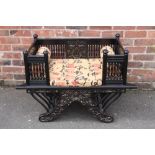 AN ANTIQUE EASTERN EBONISED ELEPHANT CHAIR, the rectangular seat with carved and spindle sides,