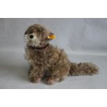 A STEIFF TREFF SKYE TERRIER PLUSH MOHAIR DOG, with button and tag to the ear H 30 cm