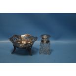 A HALLMARKED SILVER PIERCED BASKET, together with a silver topped bottle (2)