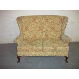 A FABRIC TWO SEATER SOFA WITH QUEEN ANN STYLE LEGS