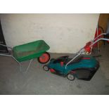 A BOSCH ELECTRIC MOWER AND A WHEELBARROW