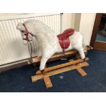 A VINTAGE ROCKING HORSE with saddle