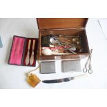 A MAHOGANY BOX OF COLLECTABLES, to include grape scissors, silver handle cake slice etc