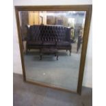 A LARGE BEVEL EDGED MIRROR