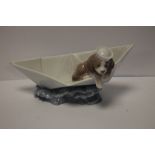 A LLADRO DOG IN A BOAT