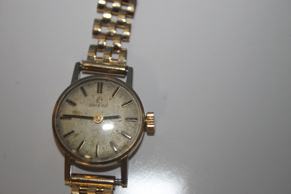 A LADIES OMEGA MANUAL WIND WRIST WATCH on an unbranded 9 ct gold strap, dedication inscription to