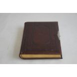 A VICTORIAN LEATHER BOUND PHOTOGRAPH ALBUM WITH CONTENTS, mainly portraits some decorated pages