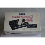 A BOXED SEGA MASTER SYSTEM II, with instuctions