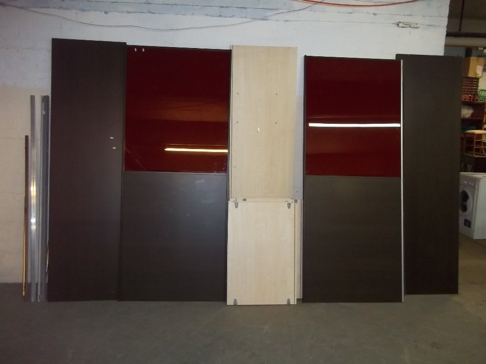 A LARGE FLAT PACK SLIDING DOOR WARDROBE