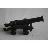 A SMALL ANTIQUE SIGNAL CANNON OF 18TH CENTURY STYLE, mounted on a brass carriage and wheels,