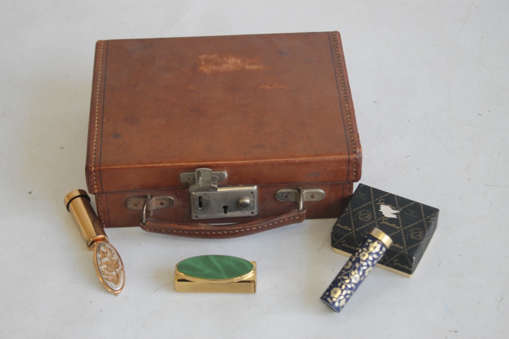 A MINIATURE CHILD'S LEATHER SUITCASE, together with a boxed stratton lipstick mirror and two other