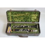 A CASED F. BUISSON B FLAT CLARINET, with cleaner and spare reeds, plate on case reads "John E.