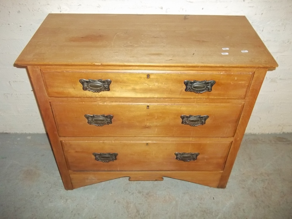 AN EDWARDIAN THREE DRAWER CHEST OF DRAWERS