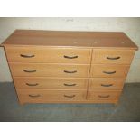 A SIX DRAWER WIDE CHEST OF DRAWERS