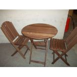 A WOODEN FOLDING PATIO TABLE SET WITH TWO CHAIRS