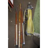 THREE VINTAGE FISHING RODS together with a collection of golf clubs