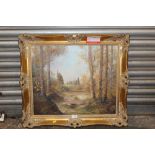 A GILT FRAMED OIL ON CANVAS OF A MOUNTAINOUS WOODED LANDSCAPE - OVERALL SIZE - 66CM X 75CM