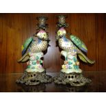 A PAIR OF MODERN CERAMIC AND METAL PARROT CANDLE STICK HOLDERS