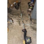 A LONG REACH TITAN PETROL STRIMMER