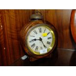 A SMALL ROUND MANTEL CLOCK BY GAMBLE WITH NOVELTY BELL ON TOP