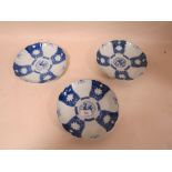 THREE ORIENTAL STYLE BLUE AND WHITE PLATES, having scalloped edging and character mark to base, Dia