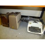 A VINTAGE OLYMPIA TYPEWRITER TOGETHER WITH A CASED VINTAGE SINGER ELECTRIC SEWING MACHINE TOGETHER