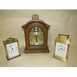 AN OAK CASED MANTEL CLOCK TOGETHER WITH TWO CARRIAGE CLOCKS