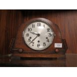 AN OAK MANTEL CLOCK