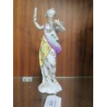 AN ANTIQUE HARD PASTE FIGURINE, as a female figure reading from a book, in the style of Serves, mar