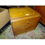 A TABLE TOP CHEST OF THREE DRAWERS