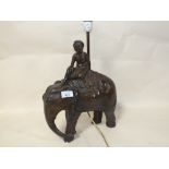 A VINTAGE INDIAN STYLE CHALK TABLE LAMP, IN THE FORM OF A FIGURE RIDING AN ELEPHANT, H 44.5 CM