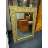 A MODERN GILT FRAMED WALL MIRROR 103 X 76 CM