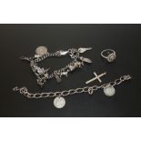 A SILVER CHARM BRACELET, TOGETHER WITH A SILVER COIN SET BRACELET (BROKEN) A SILVER CROSS PENDANT