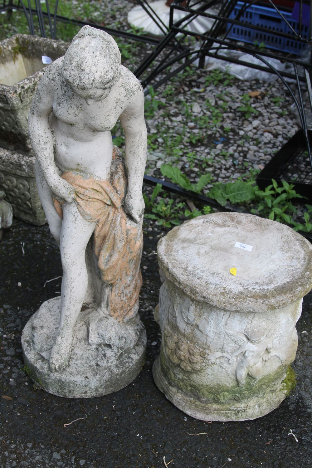 A CHERUBIC DESIGN STONE PLINTH TOGETHER WITH A STONE NUDE FEMALE FIGURE
