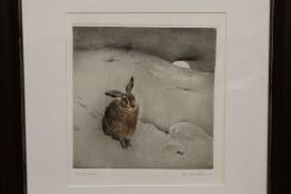 A FRAMED AND GLAZED ORIGINAL ETCHING OF A HARE IN A MOONLIT SNOWY LANDSCAPE SIGNED LOWER RIGHT,