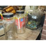 A LARGE GLASS JAR CONTAINING VINTAGE MARBLES TOGETHER WITH TWO SWEET JARS