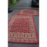 A VINTAGE RED WOOLLEN RUG