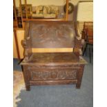 A CARVED OAK MONKS BENCH, W 83 CM