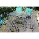 A GLASS TOPPED METAL FRAMED GARDEN TABLE WITH FOUR CHAIRS