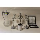 A SILVER PLATED CUT GLASS CLARET JUG TOGETHER WITH A PAIR OF CANDLE STICKS, CANDELABRA, CASED CAKE