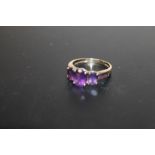 A HALLMARKED 9 CARAT GOLD THREE STONE AMETHYST RING, APPROX WEIGHT 2.7G