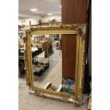 A LARGE 19TH CENTURY GOLD DECORATIVE SWEPT FRAME - WITH DAMAGES, frame W 17 cm, rebate 120 x 97 cm