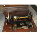 A MAHOGANY CASED VINTAGE SINGER SEWING MACHINE