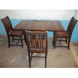 AN ANTIQUE OAK DROP LEAF DINING TABLE AND THREE CHAIRS